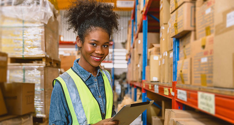 woman worker black African girl teen work cargo warehouse inventory staff portrait happy smile
