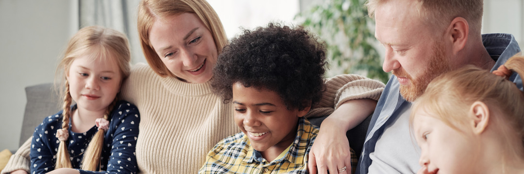 Happy children with foster parents at home