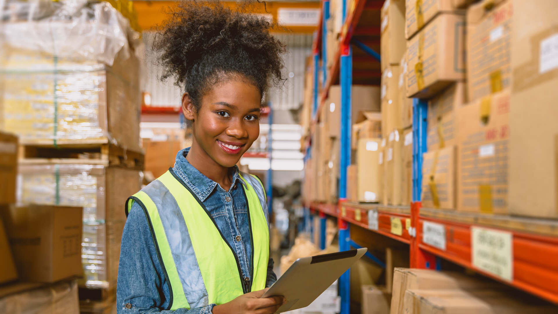 woman worker black African girl teen work cargo warehouse inventory staff portrait happy smile